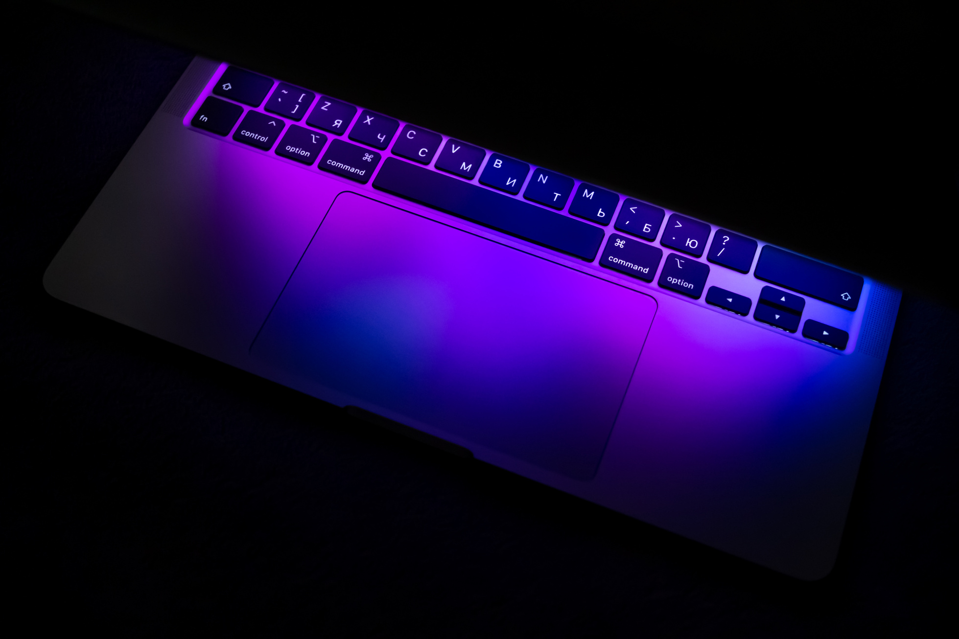 Close-Up Shot of Neon Lights Reflection on a Laptop